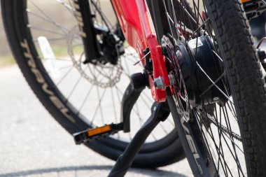 Ukraine Dnipro 05.04.2021 - a new red electric bike stands in a park in nature, new technologies