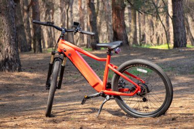 Ukraine Dnipro 05.04.2021 - a new red electric bike stands in a park in nature, new technologies