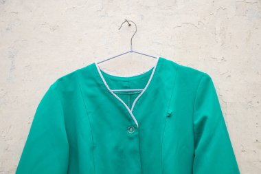 Ukrayna 'nın sokaklarında asılı duran bir askıda asılı eski bir tıbbi takım elbise, hemşire üniforması.