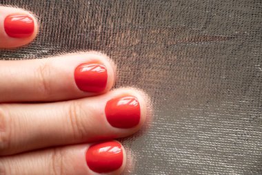 Kırmızı manikürlü kadın elleri izole edilmiş arka planda.