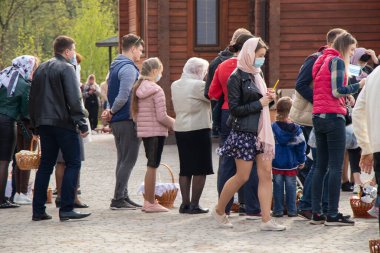 Ukrayna Dnipro, Dnipropetrovsk 02.05.2021 - Rahip Paskalya sepetlerini yiyecekle kutsadı. Tapınaktaki Hristiyanlar. Paskalyayı Ukrayna ve Paskalya 'da kutlama gelenekleri