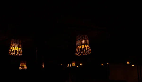 wicker straw street lamps glow in the dark, a lantern in the dark made of environmentally friendly materials