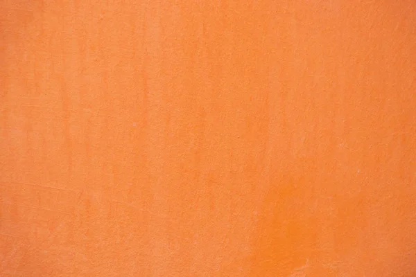 light orange painted wall outdoors as background close-up, pink background