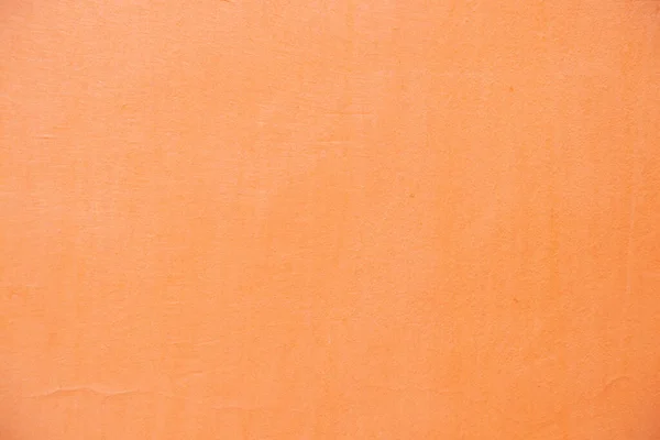 light orange painted wall outdoors as background close-up, pink background