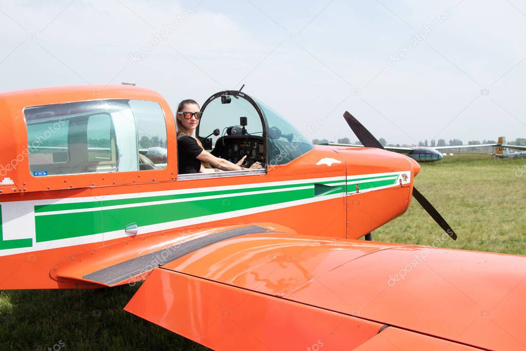 a girl driving a four-seater plane at an airfield in Ukraine in the city of Dnipro, driving an airplane