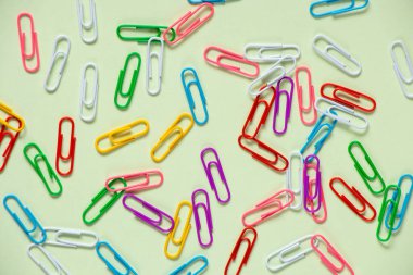 multicolored paper clips on isolated background close up