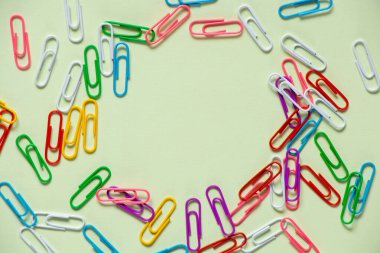 multicolored paper clips on isolated background close up