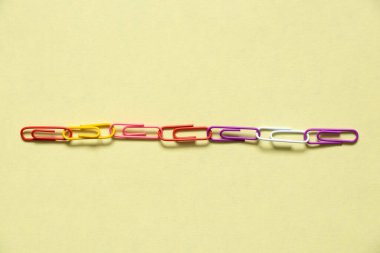 multicolored paper clips on isolated background close up