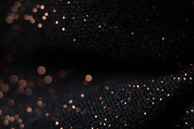 bulanık odaklı parlak lekeli siyah kumaş, arka plan için makro fotoğraf