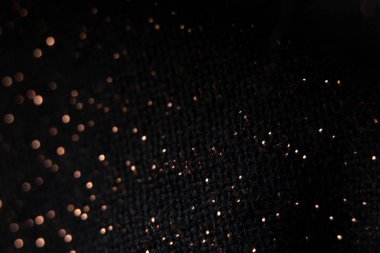 bulanık odaklı parlak lekeli siyah kumaş, arka plan için makro fotoğraf