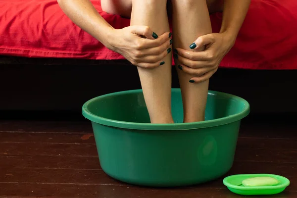 Κορίτσι Πλένει Πόδια Της Ένα Μπολ Νερό Στο Ξύλινο Πάτωμα — Φωτογραφία Αρχείου