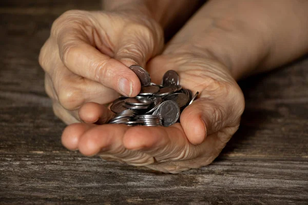 hands of an old woman with pennies on the table, money in the hands of a pensioner