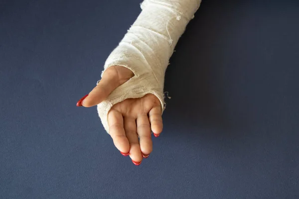 two female hands with broken wrists after falling from a bicycle in a cast on an isolated background, hands in a cast