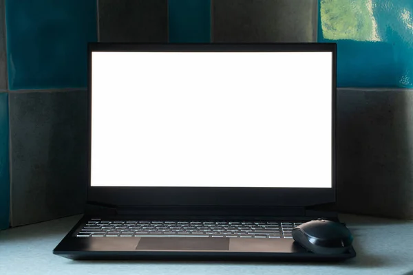 black laptop with white screen stands on the kitchen on the table at home, laptop with white screen, template, laptop on the table