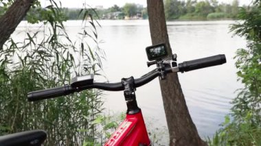 Ukrayna Dnepr 14.08.2021 - GoPro HERO 9, parktaki elektrikli bir bisikletin gidonuna sabitlendi.