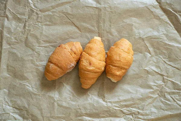 Three Croissants Lie Crumpled Brown Paper Cafe Croissants — Stock Photo, Image