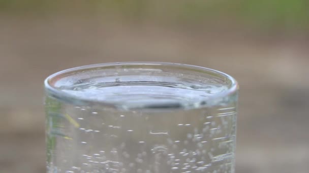 水滴はガラスの中の水や水滴の中に落ち — ストック動画