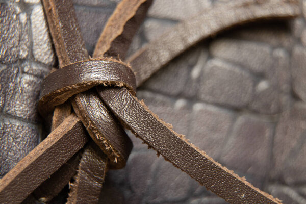 brown leather lace tied with a knot on men's loafers macro photo, leather laces in shoes