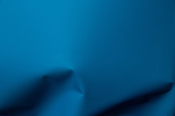 Blue wrinkled packaging film as a background, wallpaper