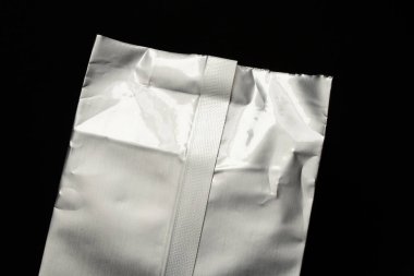 Gri gıda termal ambalajı, yiyecek depolama ve korunma için siyah arka planda yakın plan.