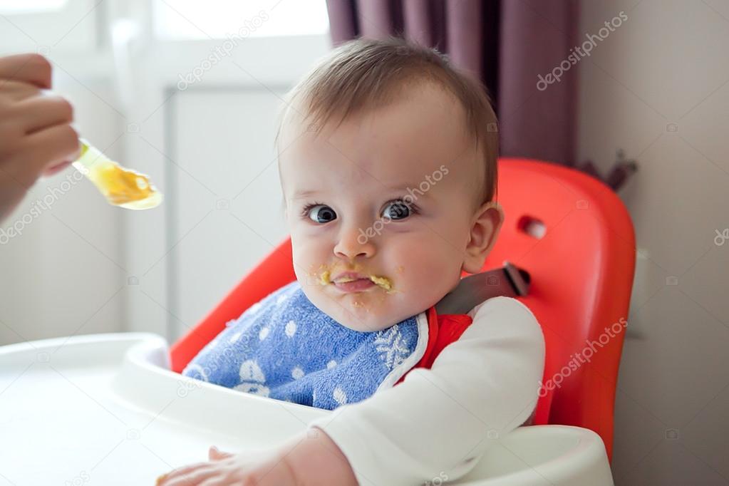 Sulky smeared baby refuses to eat a meal