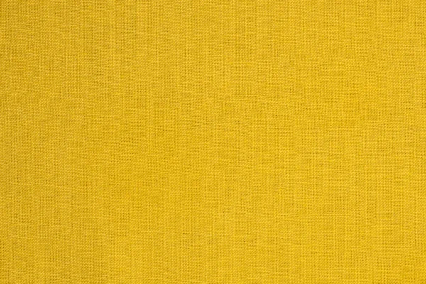 Close-up de uma textura têxtil de tecido amarelo — Fotografia de Stock