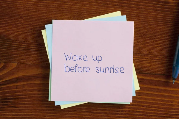 Wake up before sunrise written on a note — Stock Photo, Image