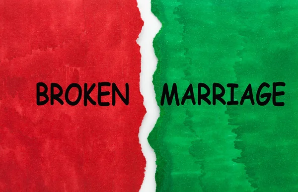 Broken marriage text on green and red torn paper.