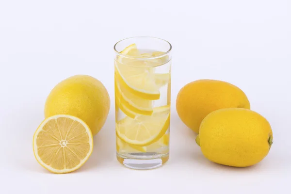 Glass of water with lemon slices — Stock Photo, Image