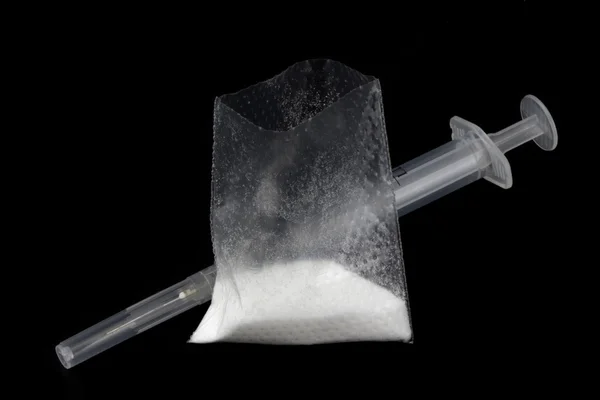 Pó droga e seringa isolada em preto — Fotografia de Stock