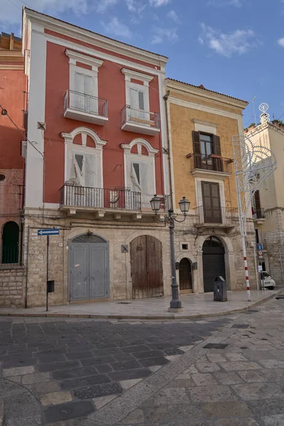 Picturesque Italian street with colorful historic houses, balconies, and traditional architecture in a sunny old town