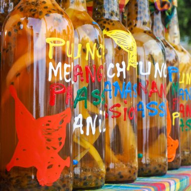Assortment of rhum bottles at the market, squared format clipart