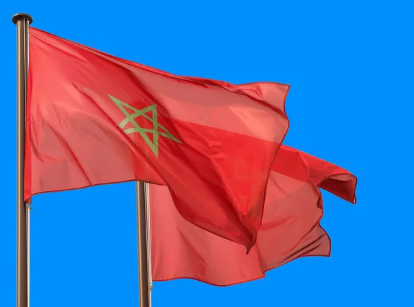 Morocco flags waving in blue sky — Stock Photo, Image