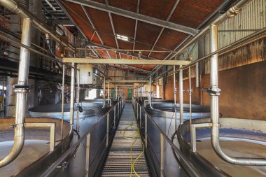 Rum plant interior view, with brewing tanks and pipes