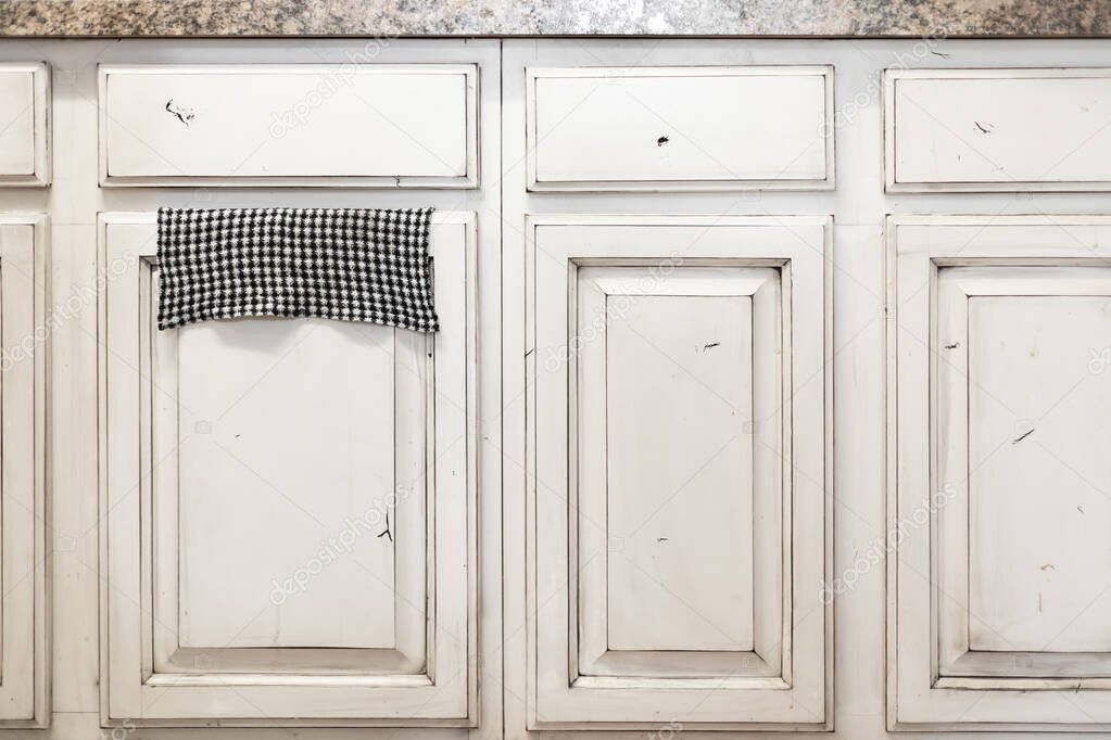 Lower row of kitchen cabinets, off white cream color, distressed wood
