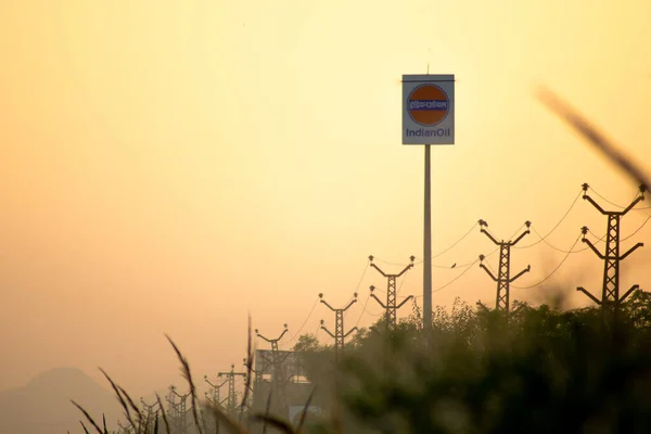Signage of indian oil petrol pump shot against a monsoon clouds and blue sky showing indias largest petroleum manufacturer and petrol pump owner