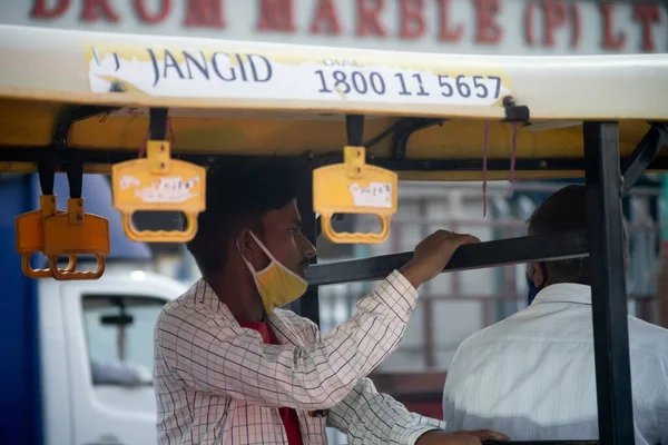 Ο άνθρωπος στις δημόσιες συγκοινωνίες ηλεκτρικά rickshaw auto κάθεται με μάσκα τράβηξε πάνω από το πηγούνι κατά τη διάρκεια της ξεκλείδωμα θέση του θανατηφόρου coronavirus covid 19 πανδημία όπως Ινδία ανοίγει σταδιακά και ανακάμπτει — Φωτογραφία Αρχείου