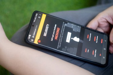 Telefon ekranında Delhivery 'nin Hintli lojistik uygulaması tek boynuzlu at teknolojisi sağlayıcısı küçük işletmelerin kurye ve nakliye hizmetleri yoluyla hareket etmesini sağlıyor.