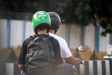 Delhi, Hindistan - 6 Ekim 2025: Hindistan başlangıç uygulaması Zypp sürücü taşımacılığı yolcuları taşıyan kurye ve bisikletli teslimat yoğun trafikte Hindistan 'da iş bulma yoluyla istihdamın arttığını gösteriyor