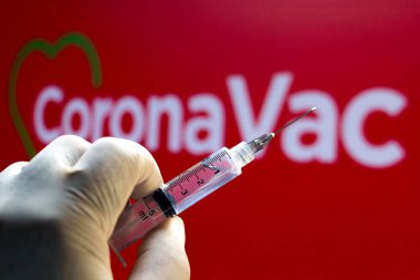 November 10, 2020, Brazil. In this photo illustration the medical syringe is seen with CoronaVac logo displayed in the background. Sinovac and Butantan Institute are testing the vaccine in Brazil clipart