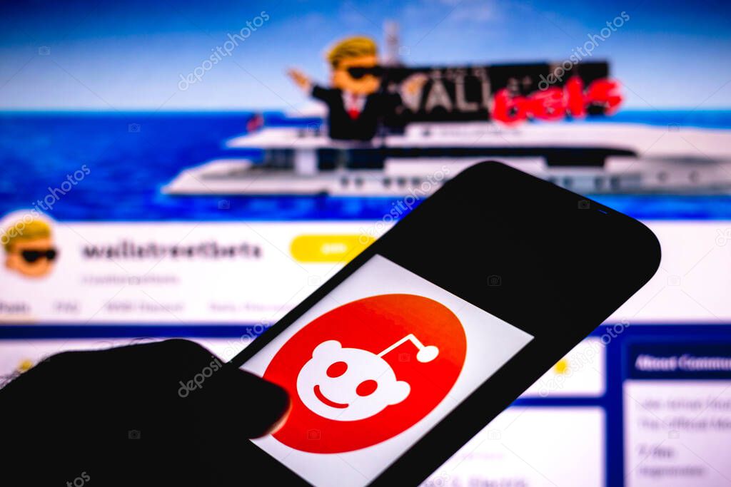 February 1, 2021, Brazil. In this photo illustration the WallStreetBets page Reddit seen in the background of a silhouette hand holding a mobile phone