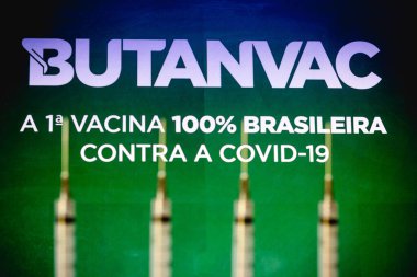 March 26, 2021, Brazil. In this photo illustration medical syringes is seen with Butanvac logo displayed in the background. The vaccine from the Butantan Institute is being developed in Brazil clipart