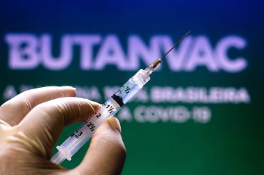 March 26, 2021, Brazil. In this photo illustration the medical syringe is seen with Butanvac logo displayed in the background. The vaccine from the Butantan Institute is being developed in Brazil clipart
