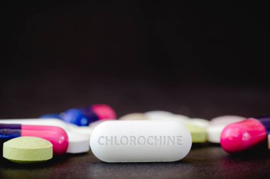 In this photo illustration medicine pills and the text CHLOROCHINE in one pill clipart