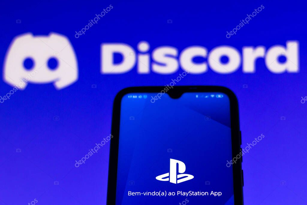 May 21, 2021, Brazil. In this photo illustration the PlayStation (PS) logo app seen displayed on a smartphone screen with the logo of Discord in the background