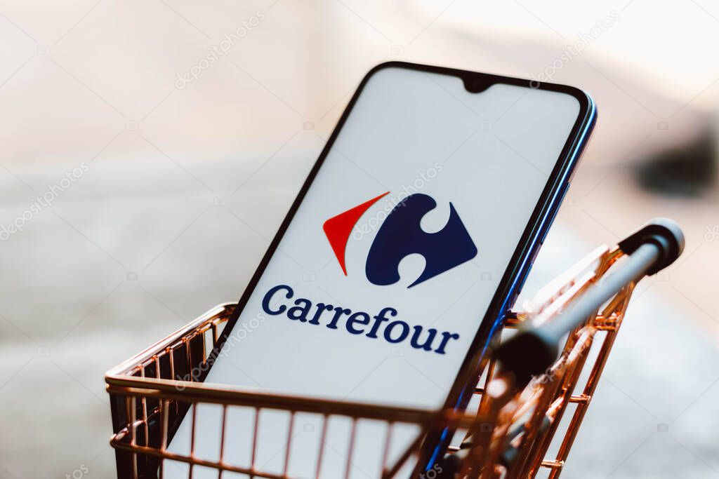 September 2, 2021, Brazil. In this photo illustration the Carrefour logo displayed on a smartphone along with a shopping cart