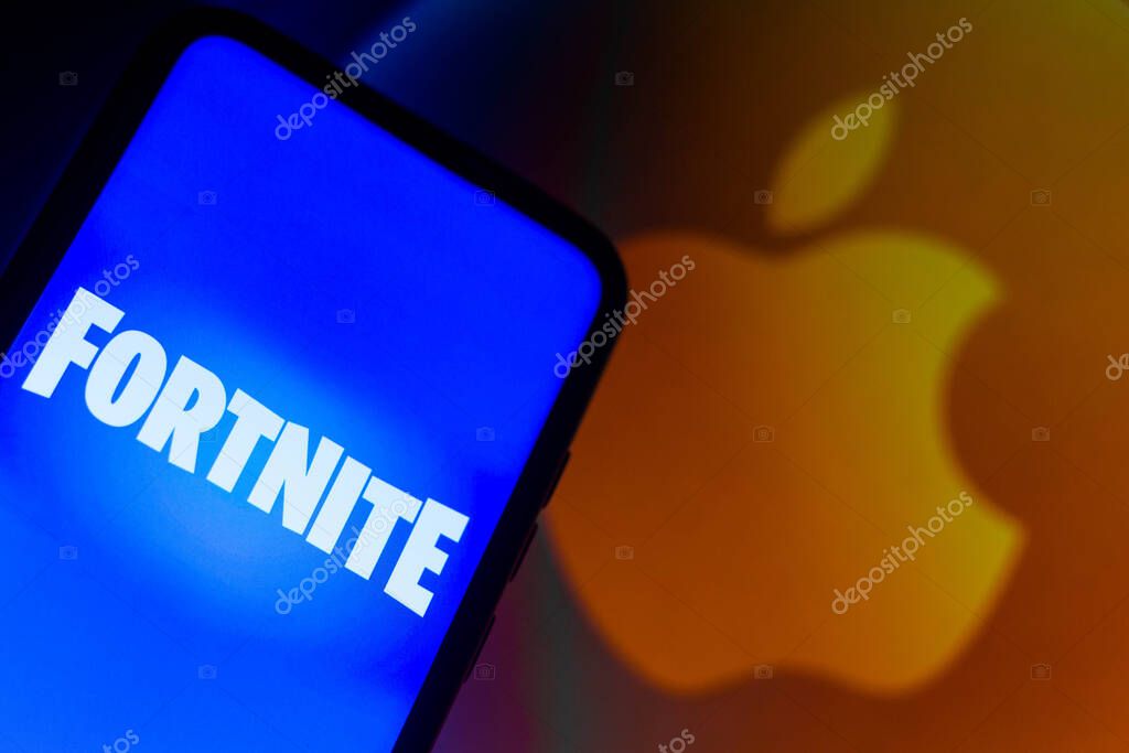 September 13, 2021, Brazil. In this photo illustration the Fortnite logo seen displayed on a smartphone with a Apple logo in the background
