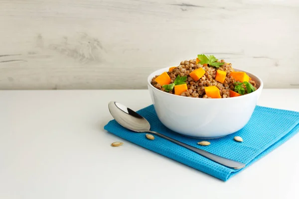 Buckwheat porridge with pumpkin and pasley in a white bowl. Russian cuisine — Stock Photo, Image