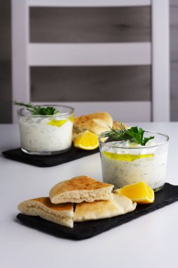 Traditional greek sauce tzatziki in two glass bowls