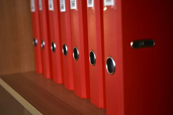 Office red folders on the shelf in the office